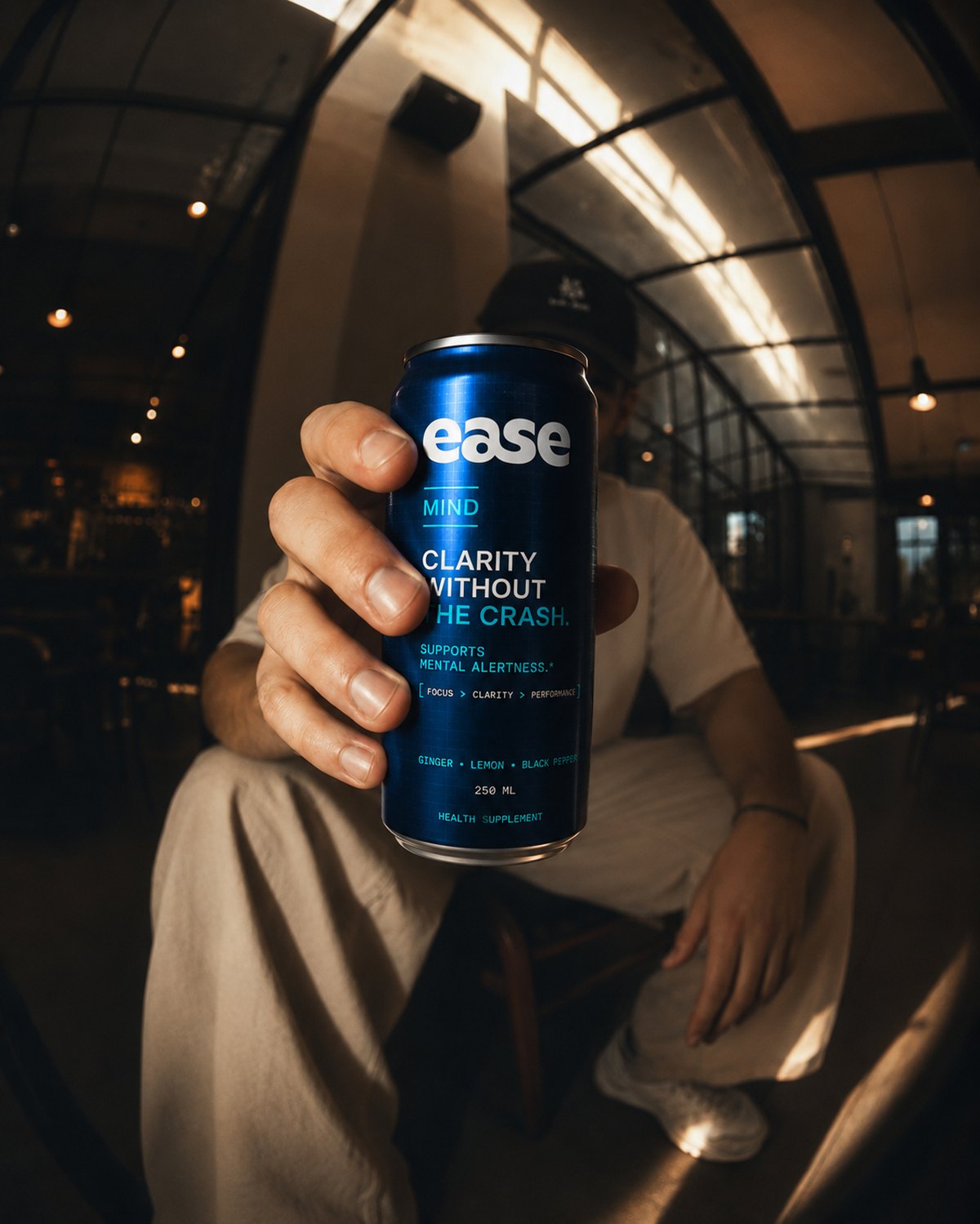 Person holding an ease MIND can in a cafe